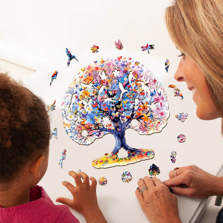 Two people assembling the colorful Life Tree wooden jigsaw puzzle, promoting focus and mental engagement.
