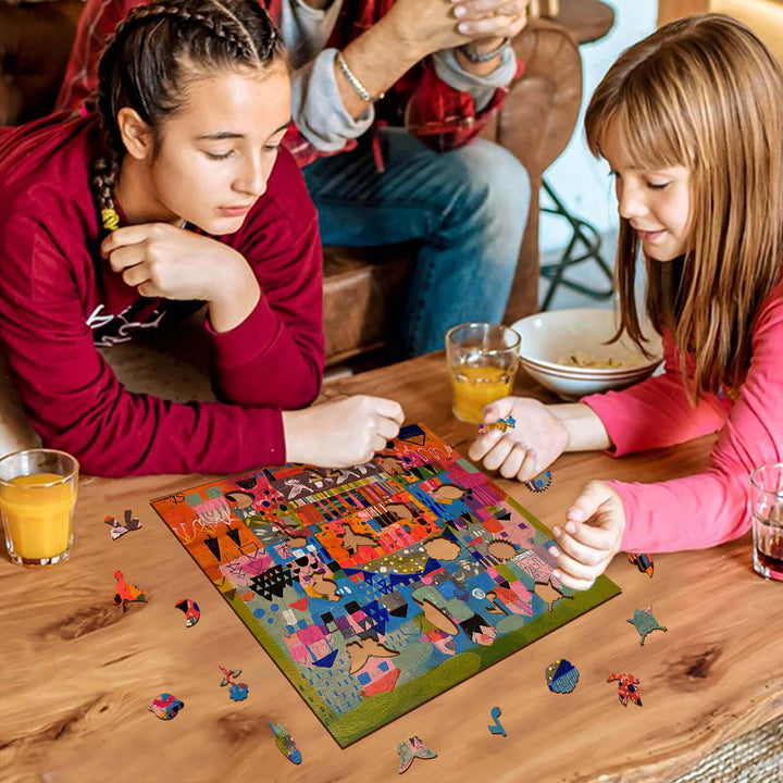 Two girls enjoying puzzle time together at a wooden table, surrounded by snacks and drinks.