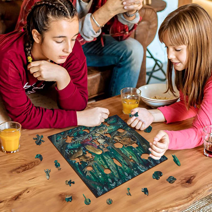 Two girls joyfully assembling a colorful puzzle together at a cozy table with drinks.