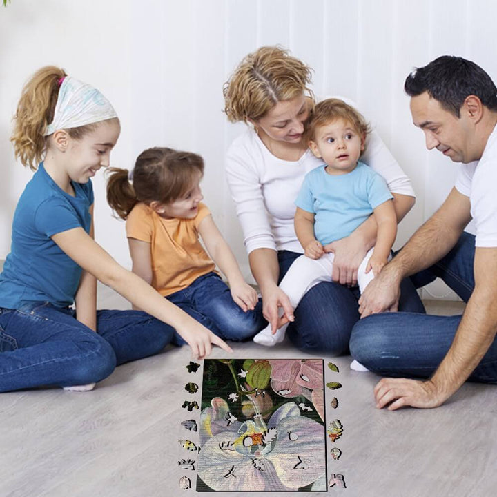 Family enjoying art together while sitting on the floor, interacting around a colorful artwork.