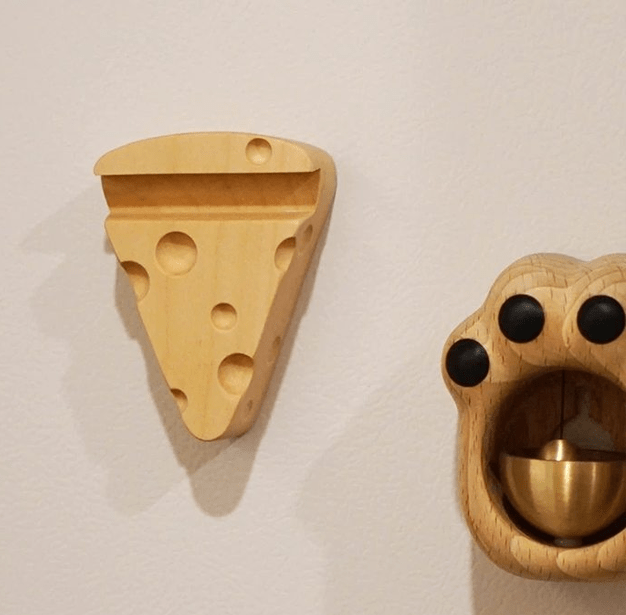 Multi-shaped wooden bottle opener in cheese and paw designs, showcasing natural maple craftsmanship.