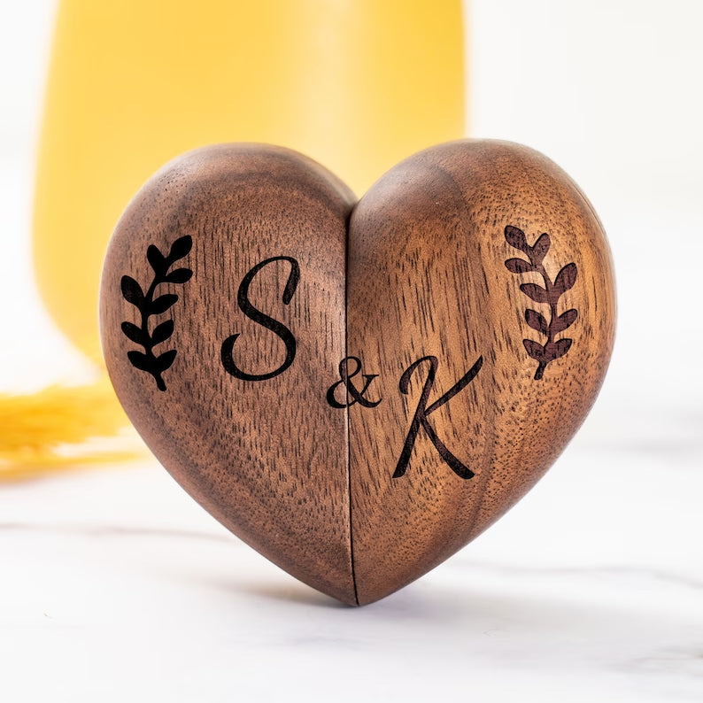 Custom walnut heart-shaped ring box with engraved initials S & K, perfect for proposals and anniversaries.