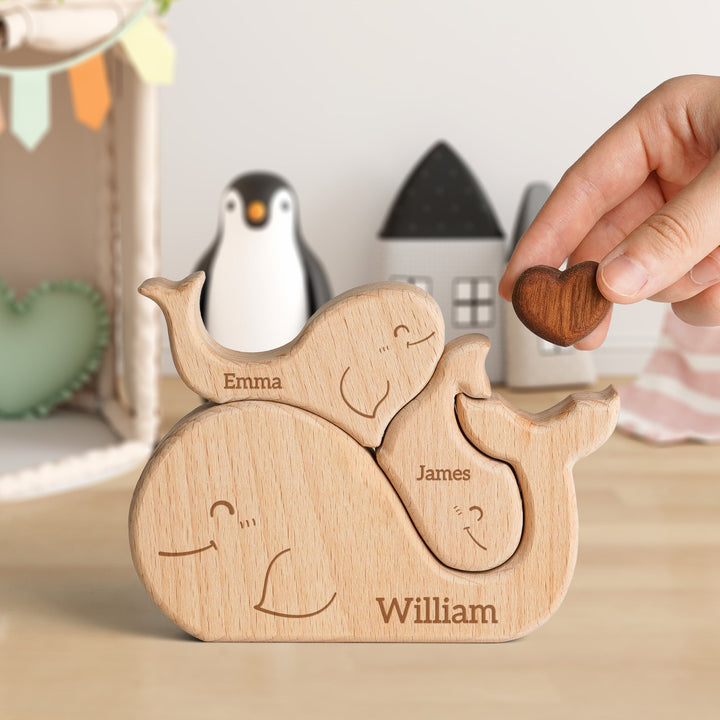 Personalized wooden whale family name puzzle featuring names Emma, James, and William, perfect for family decor.