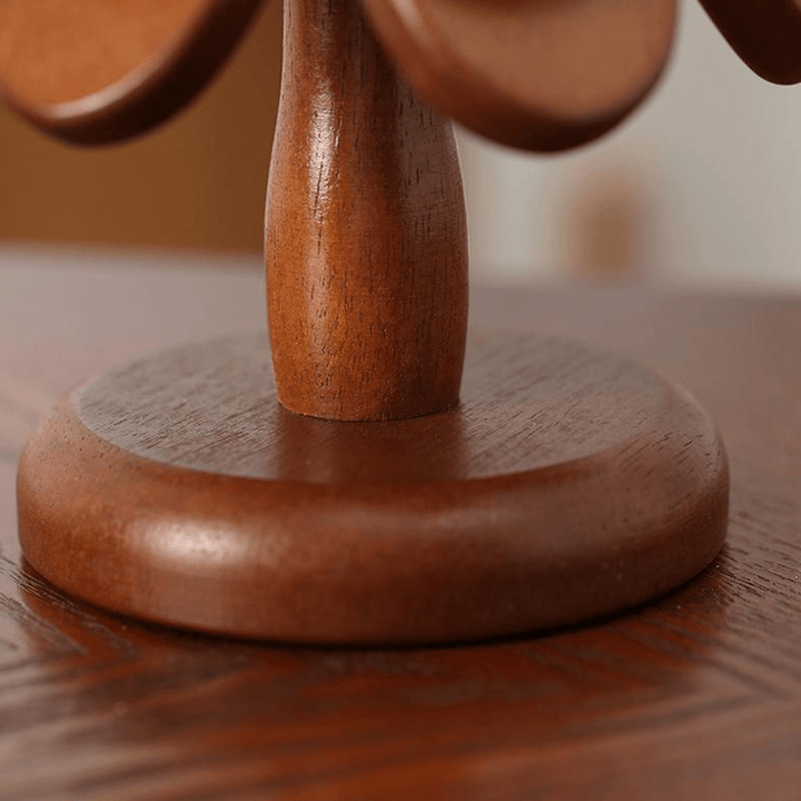 Close-up of a wooden base of a Christmas tree coaster highlighting the natural wood grain and finish.