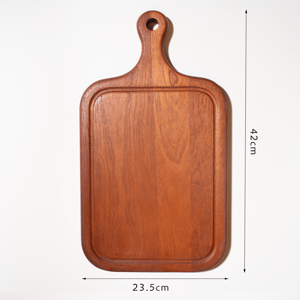 Ebony cutting board with built-in juice groove, 42cm x 23.5cm, ideal for cooking and kitchen decoration.
