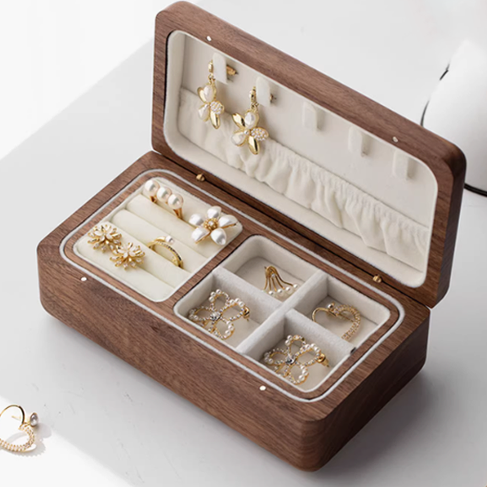 Elegant wooden double-layer jewelry box with gold jewelry organized inside.