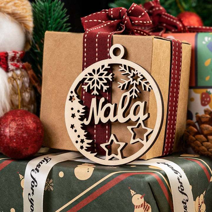 Personalized wooden ornament featuring the name Nala, decorated with snowflakes and stars, perfect for holiday gifting.