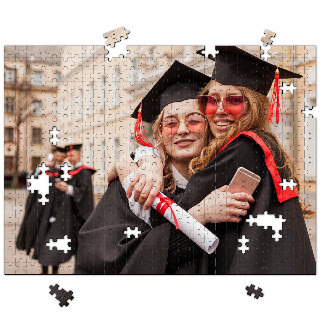 Graduates celebrating with a custom photo puzzle, capturing joyful graduation memories in a 1000-piece jigsaw.