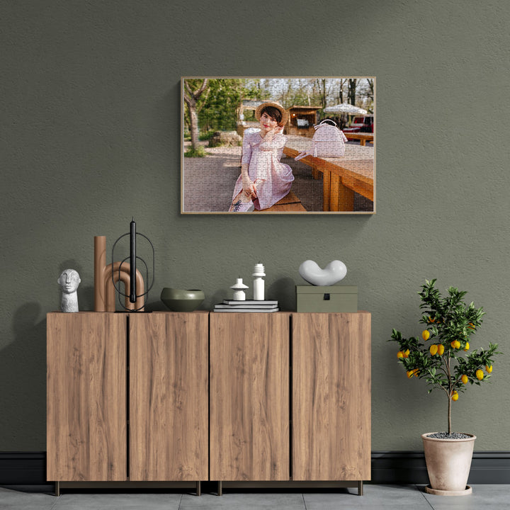 Personalized photo puzzle hanging above a wooden cabinet, showcasing a woman in a lovely outdoor setting.