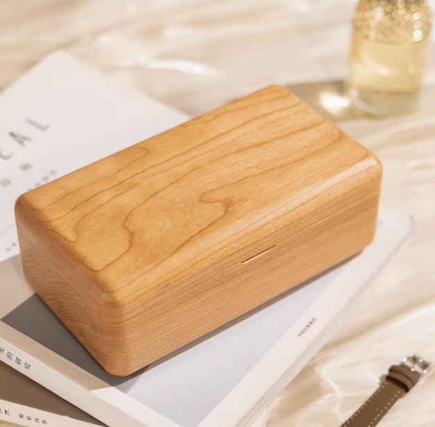 Elegant wooden double-layer jewelry box with natural grain design, placed on glossy surface.
