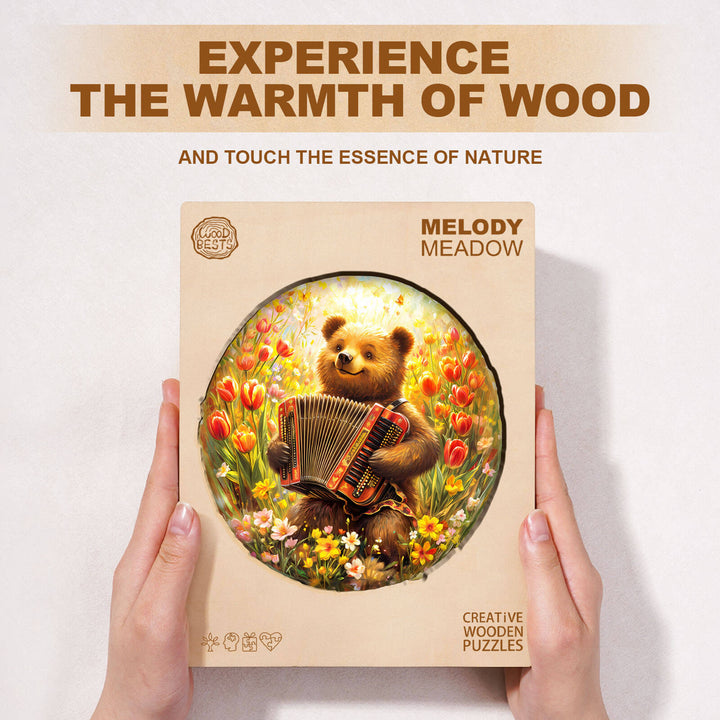 Melody Meadow wooden jigsaw puzzle packaging with bear playing accordion surrounded by flowers.