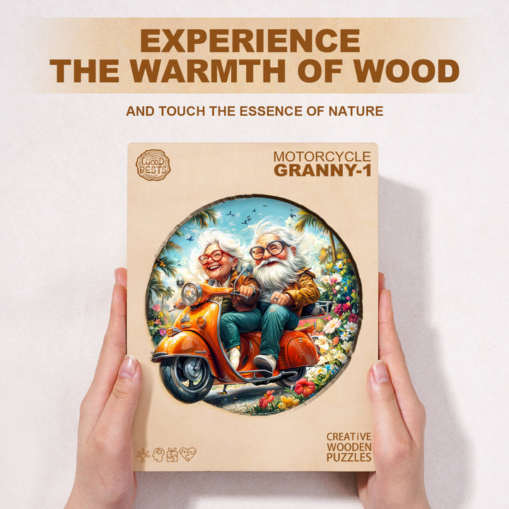 Motorcycle Granny-1 wooden jigsaw puzzle box featuring two elderly characters riding a scooter surrounded by nature.