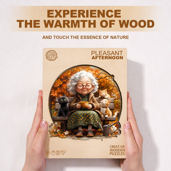 Pleasant Afternoon Wooden Jigsaw Puzzle featuring a joyful grandmother with cats in a nature setting.