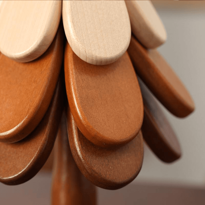 Close-up of wooden Christmas tree coasters showcasing natural wood textures and artistic design.