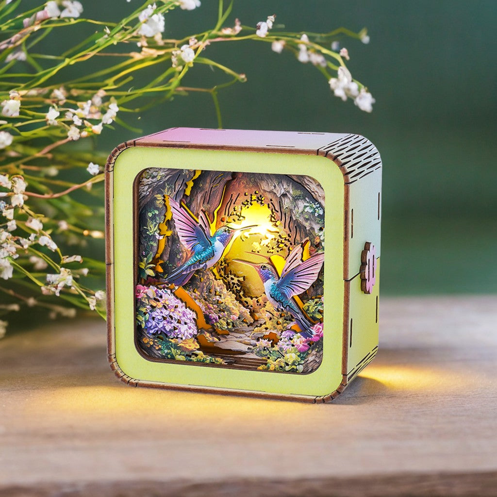 3D wooden puzzle night light featuring colorful hummingbirds and a serene garden scene.
