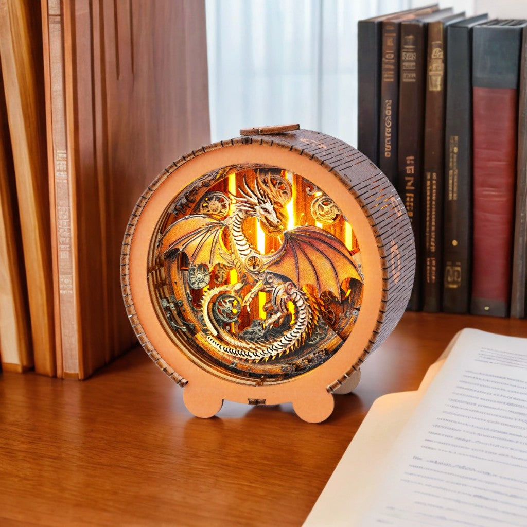 Mechanical dragon kit 3D wooden puzzle night light on a table surrounded by books, showcasing intricate design and warm glow.