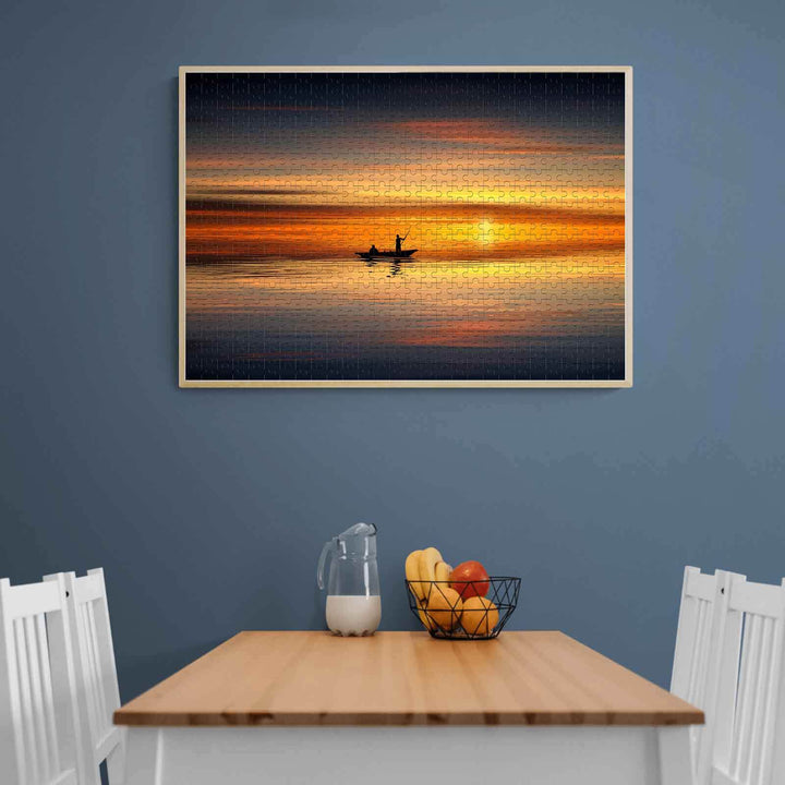 Boatman at Sunset 500/1000 piece puzzle displayed on a wall above a dining table, enhancing interior decor.