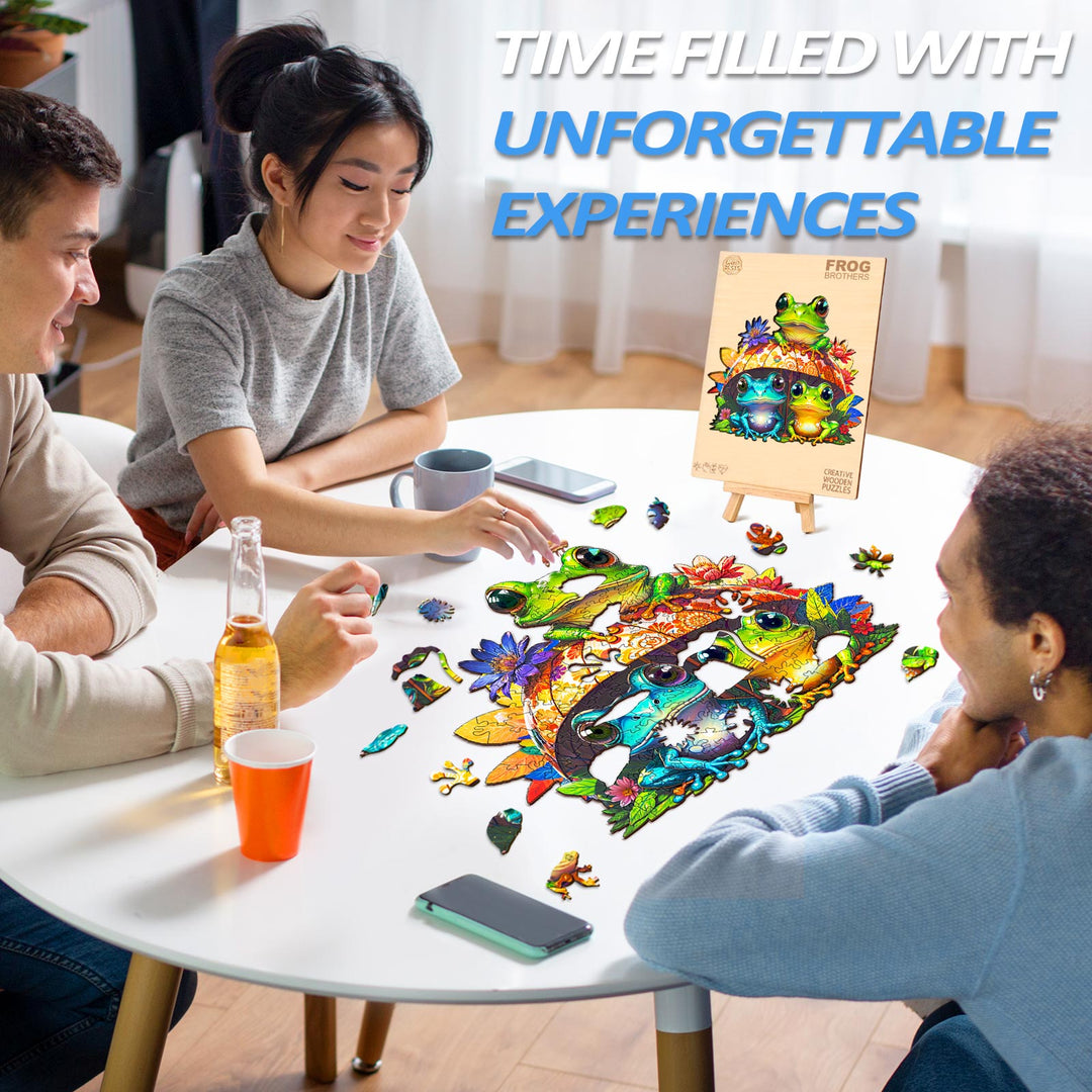 Group of friends enjoying a Frog Brothers wooden jigsaw puzzle on a table, creating unforgettable experiences together.