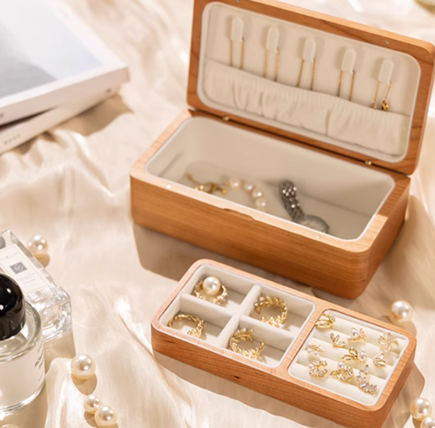 Elegant wooden double-layer jewelry box with organized compartments for rings, earrings, and necklaces.