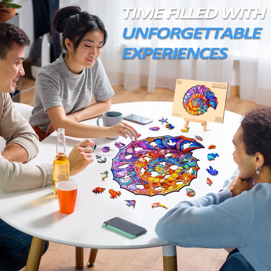 Friends enjoying the Colorful Nautilus Wooden Jigsaw Puzzle on a table full of pieces for a fun game night.
