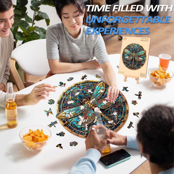 Group enjoying the Vintage Dragonfly Wooden Jigsaw Puzzle while sharing drinks and snacks.
