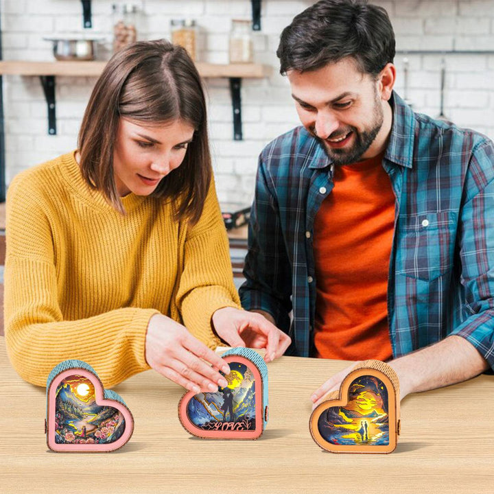 Couple assembling a 3D wooden heart puzzle night light, showcasing colorful designs and enjoying a creative moment together.