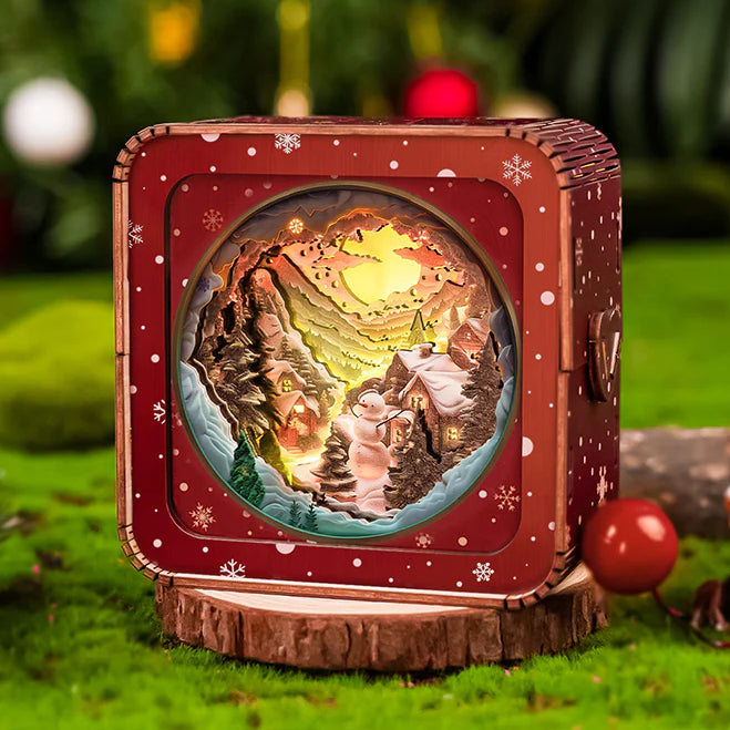 3D wooden puzzle night light featuring a snowy mountain scene with a cozy hut and festive decorations.