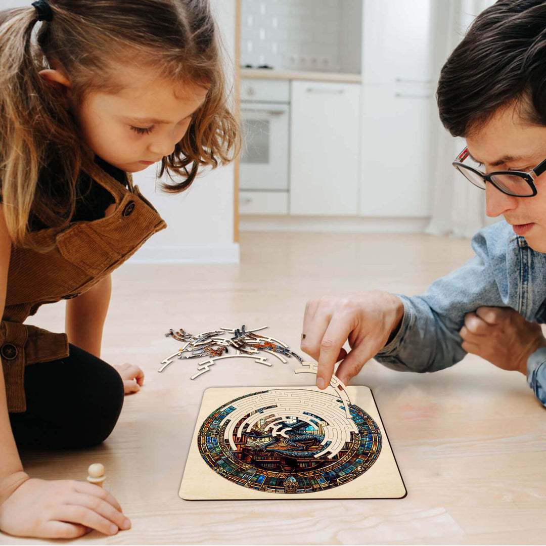 A child and an adult assembling the Maze Puzzles—Library Dragon jigsaw puzzle on the floor, promoting focus and cognitive skills.