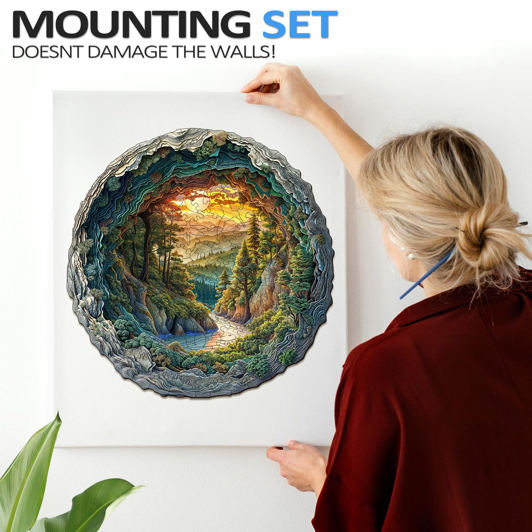 Person mounting a 3D cave forest jigsaw puzzle on the wall, showcasing its vibrant colors and intricate design.