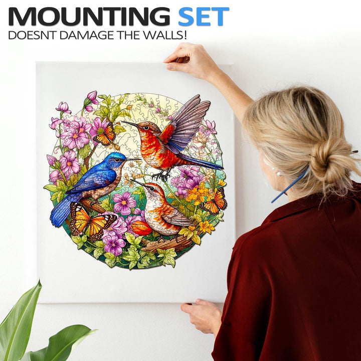 Birds and butterflies wooden jigsaw puzzle displayed on wall, showcasing vibrant colors and nature theme.
