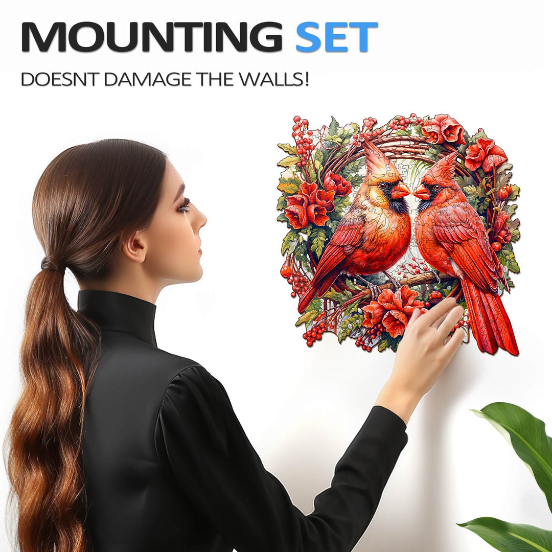 Woman installing a Cardinal wooden jigsaw puzzle with a mounting set, ensuring no wall damage.