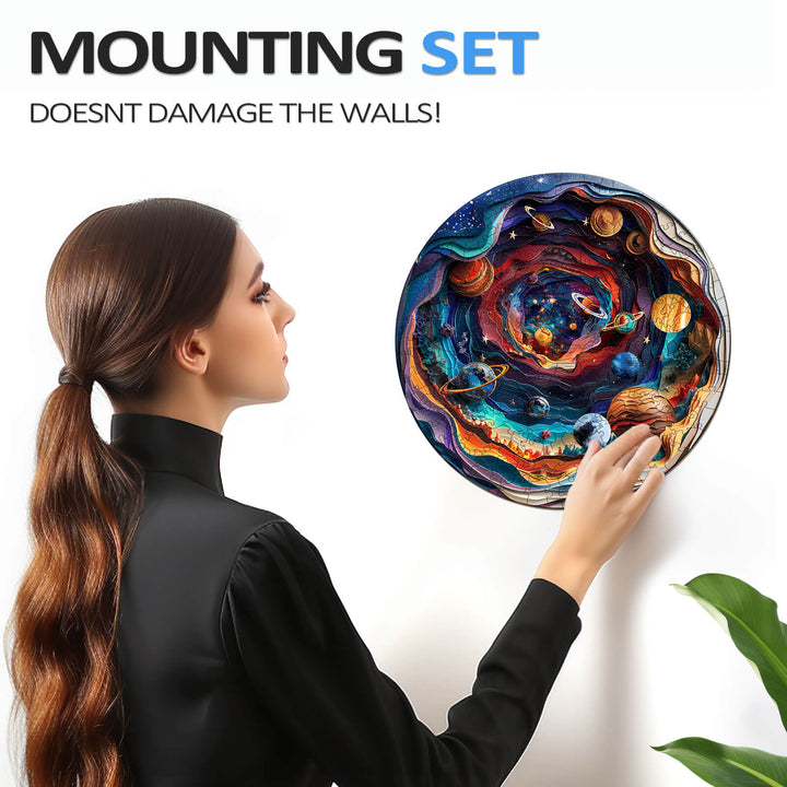 Person mounting the 3D Universe wooden jigsaw puzzle on a wall without damage, showcasing vibrant colors and celestial design.