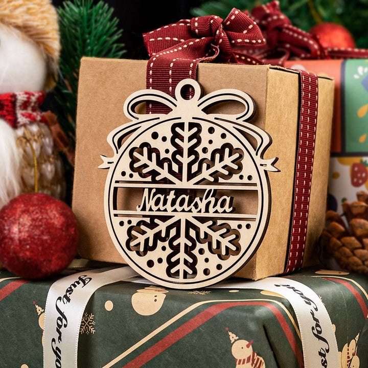 Personalized wooden ornament tag with snowflake design and name 'Natasha', ideal for Christmas gifting and decoration.