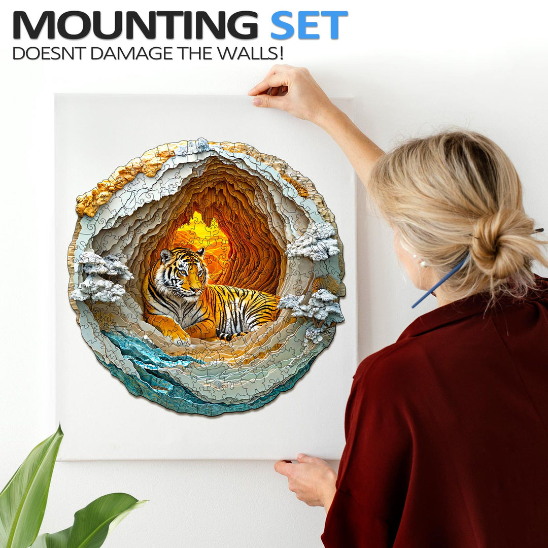Woman mounting a 3D Tiger puzzle in a cave design on the wall without damaging it.