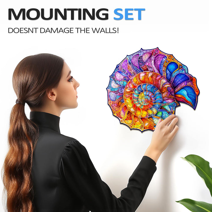 Woman mounting a colorful nautilus puzzle on the wall using a damage-free set, showcasing vibrant artwork.