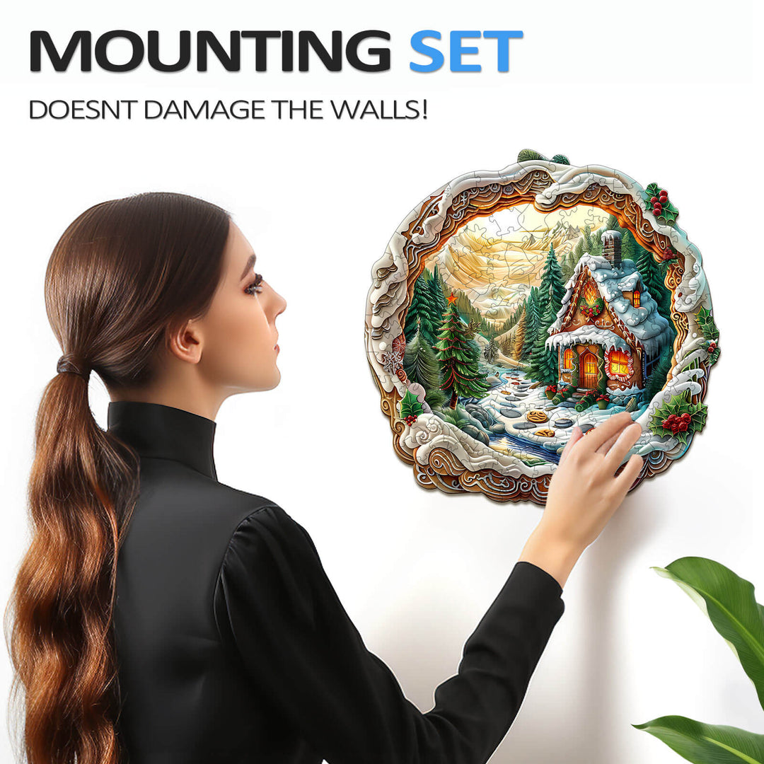 Woman mounting a 3D Christmas House jigsaw puzzle on the wall using a damage-free mounting set.