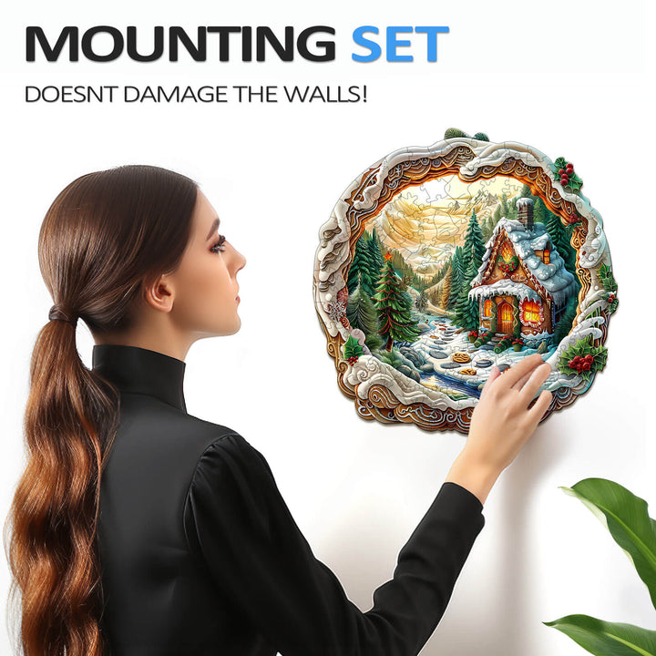 Woman mounting a 3D Christmas House jigsaw puzzle on the wall using a damage-free mounting set.
