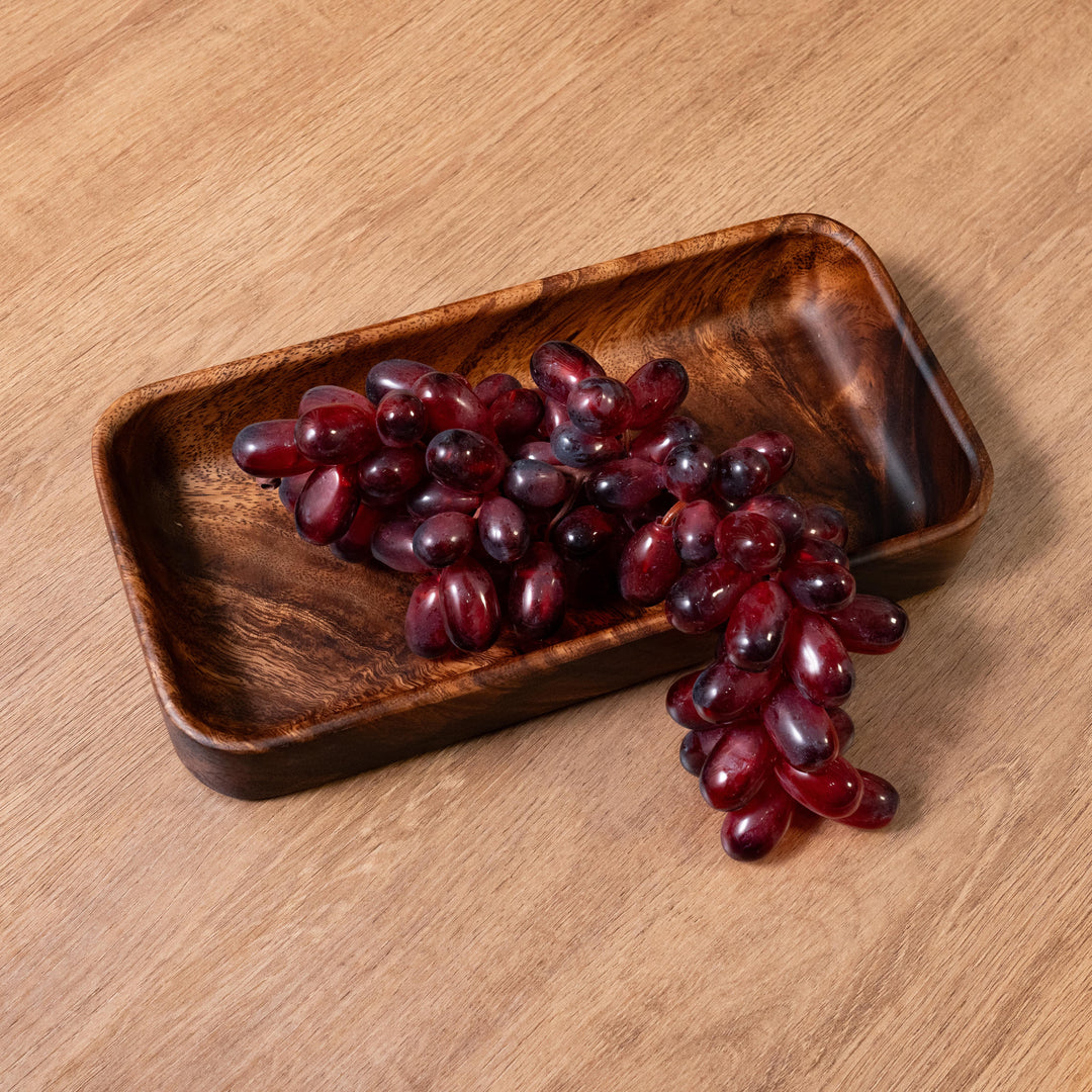 Acacia wood dinner plate showcasing a cluster of red grapes, exemplifying natural elegance in dining.