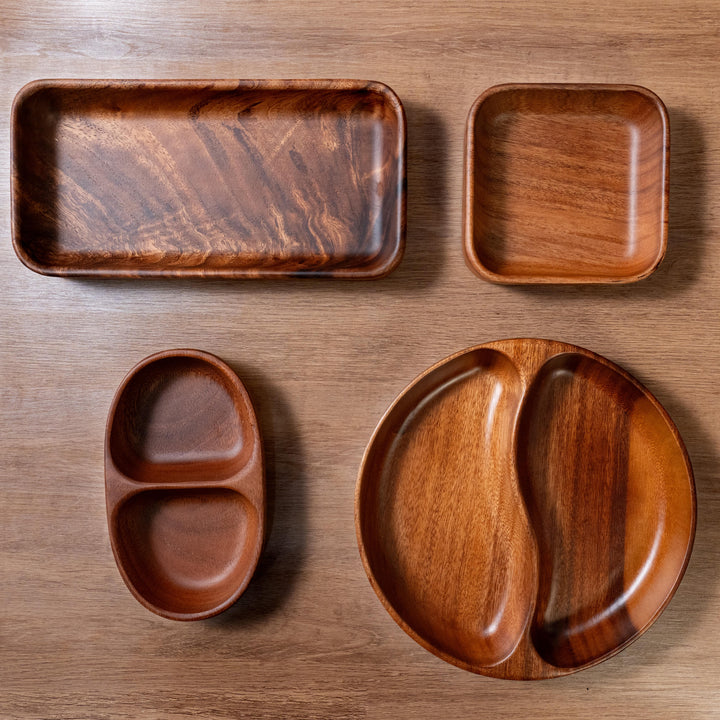 Set of organic acacia wood dinner plates and bowls showcasing natural texture and elegance.
