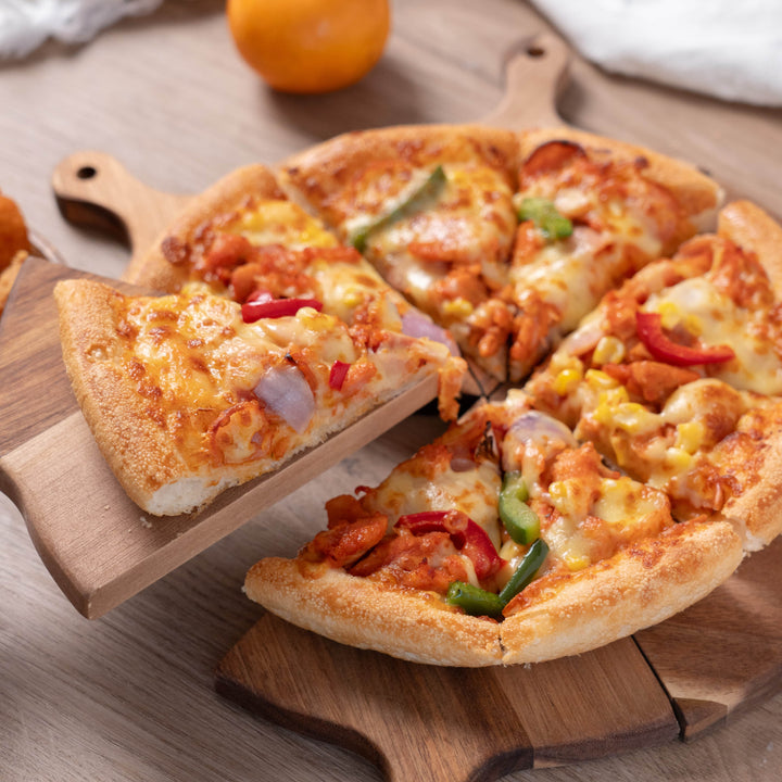 Delicious pizza served on a stylish acacia wood pizza serving tray, showcasing colorful toppings and easy portioning.