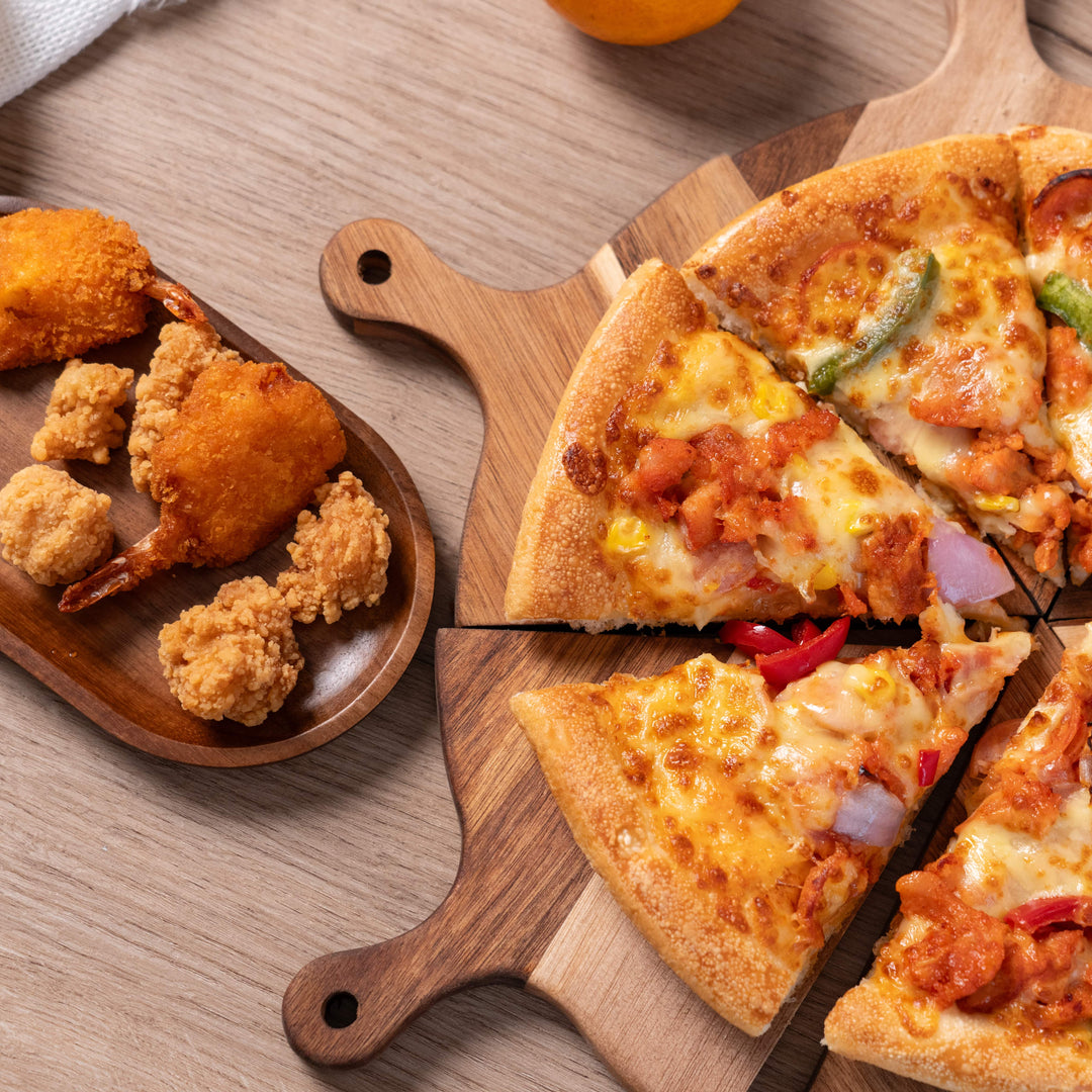 Acacia wood pizza serving tray with sliced pizza and golden fried snacks, perfect for sharing delicious meals.