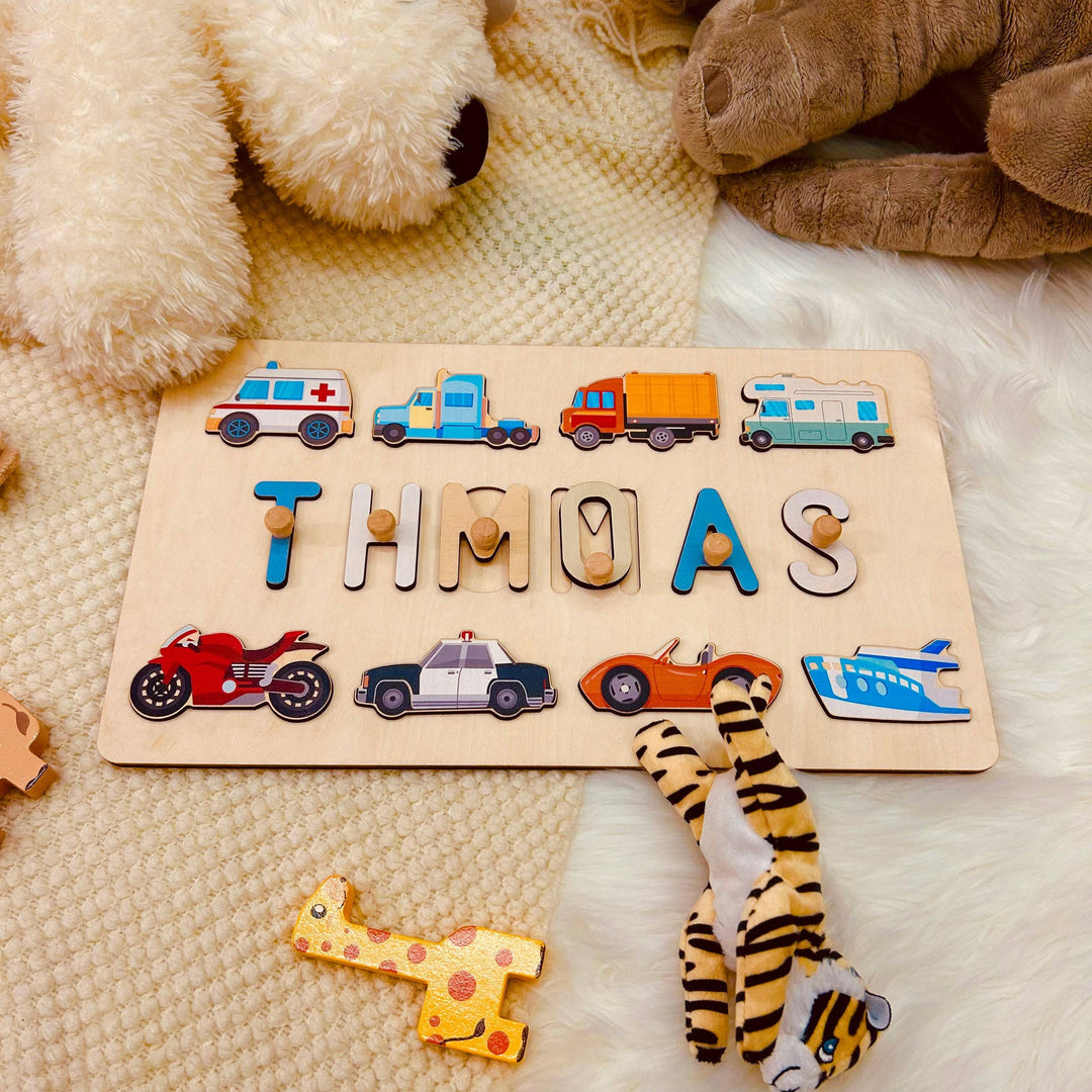 Personalized wooden baby name puzzle featuring the name 'THOMAS' with colorful traffic icons.