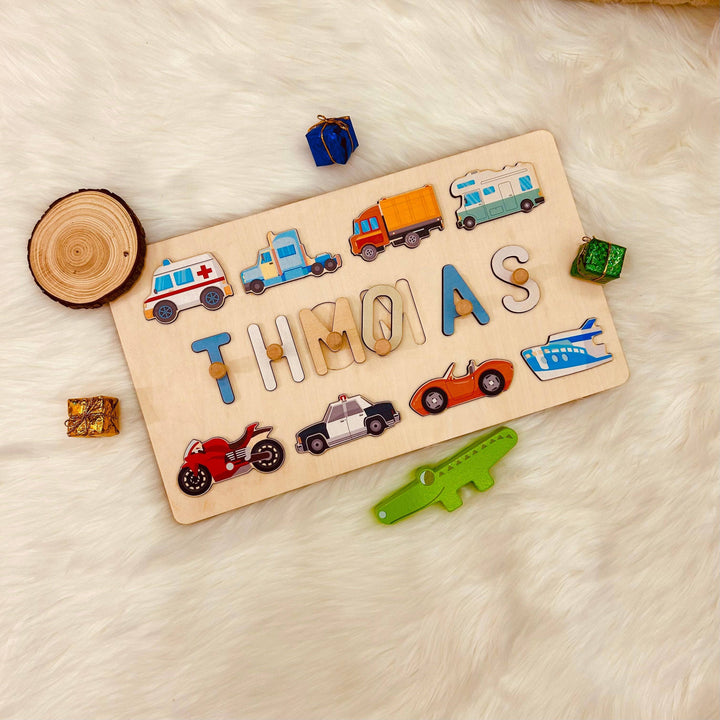 Personalized wooden baby name puzzle with traffic vehicles spelling THOMAS, made from eco-friendly materials.