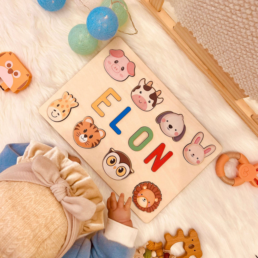 Personalized wooden baby name puzzle featuring colorful letters and animal icons for the name ELON.