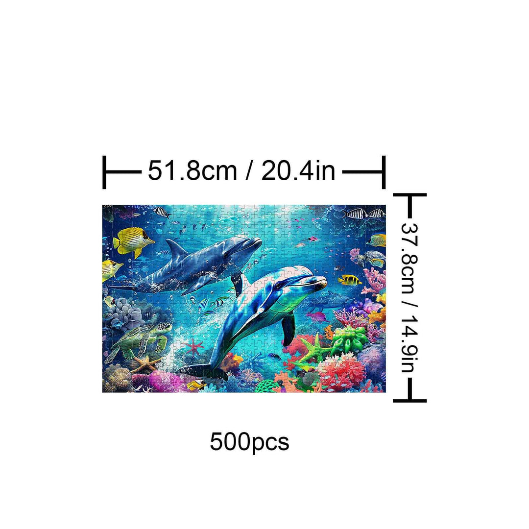 Undersea Paradise 500-piece puzzle illustration featuring dolphins and colorful marine life in vibrant underwater scene.