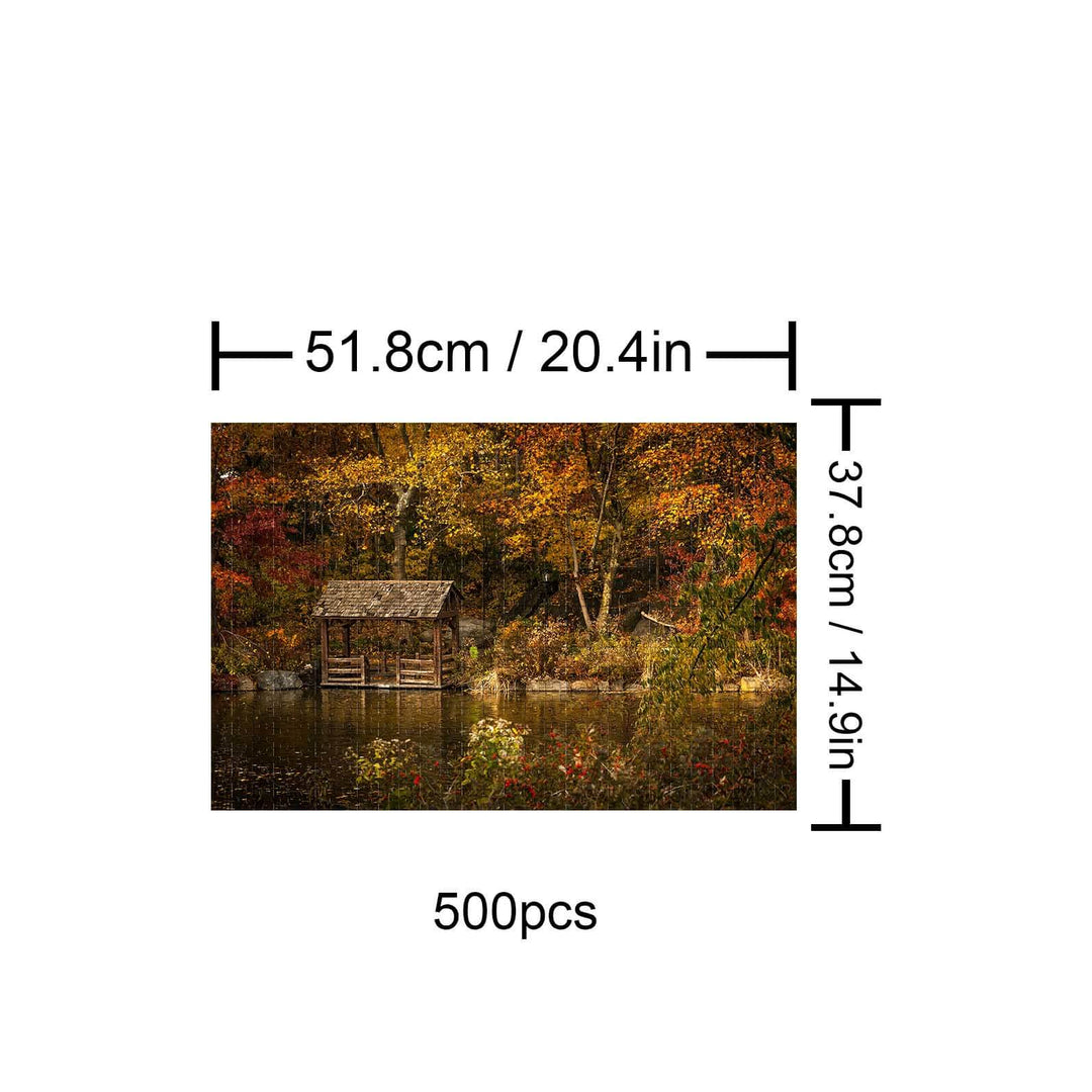 Autumn Lakeside 500-piece puzzle featuring a serene lakeside cabin surrounded by colorful fall foliage.