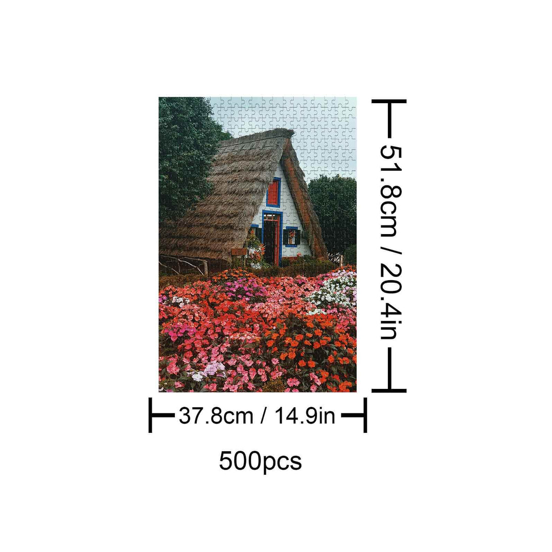 500 piece Flower House jigsaw puzzle featuring a charming cottage surrounded by colorful flowers, dimensions included.