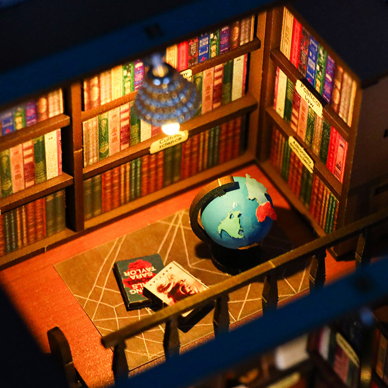 Detailed miniature book nook with globe, colorful bookshelves, and cozy lighting in a DIY 3D wooden puzzle.