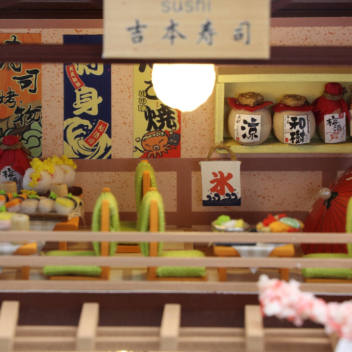 Interior view of Sakura Sushi House DIY Dollhouse Kit showing detailed sushi displays and colorful decor.