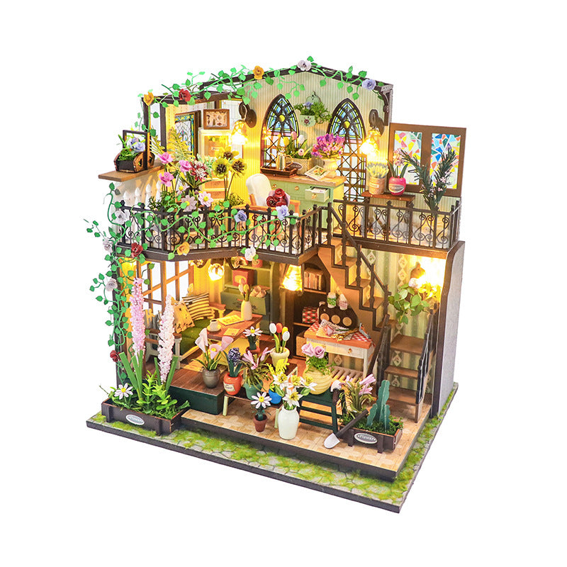 Daisy's Flower Room DIY dollhouse kit showcasing detailed miniature design with plants and lighting.